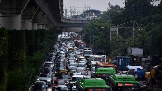 Slow moving traffic due to the rain, near Moti Bagh in New Delhi on July 28. Traffic jams were recorded on both days across several parts of the city and the Delhi traffic police noted nearly 50 stretches being inundate, with pumps used to flush out excess water.(Sanjeev Verma / HT Photo)