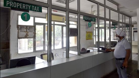 A resident who came to submit property tax stands at a deserted counter at MC office in Ludhiana on Thursday. (GURPREET SINGH/HT)