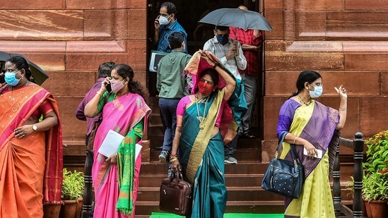 YSR Congress party leader Geetha Viswanath (C) and others taking cover from the rain while at the Parliament for the Monsoon Session, in New Delhi on July 28.(Arun Sharma / PTI)