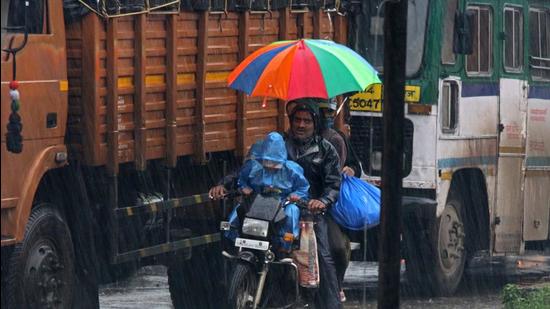A family out in rain on a bike in Pune. Pune district receives excess rainfall in July. (HT) A family out in rain on a bike in Pune. Pune district receives excess rainfall in July. (HT)