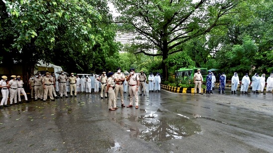 Police personnel stand guard during a "Kisan Sansad" protest against three farm reform laws, at Jantar Mantar in New Delhi, on July 28. Mahesh Palawat, vice-president (meteorology and climate change) at Skymet Weather, a private weather forecaster, told HT that despite a late start to monsoon, Delhi has managed to exceed the rainfall usually seen in July.(Vijay Verma / PTI)