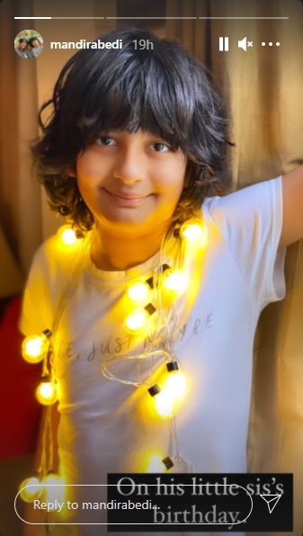Vir smiled for the camera as he posed with bulb string lights hung around his neck.