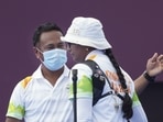 India's Deepika Kumari with coach Dharmendra Tiwary after winning in the women's individual 1/8 eliminations round of the archery event, at the Summer Olympics 2020.