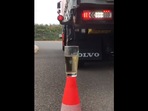 The image is taken from the video that shows a driver dunking a teabag into a glass of water using his truck.