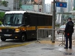 A prison van arrives as a police officer stands guard for Tong Ying-kit's arrival at the Hong Kong High Court in Hong Kong Friday, July 30, 2021. Tong was convicted Tuesday of inciting secession and terrorism for driving his motorcycle into a group of police officers during a July 1, 2020, pro-democracy rally while carrying a flag bearing the banned slogan, A prison van arrives as a police officer stands guard for Tong Ying-kit's arrival at the Hong Kong High Court in Hong Kong Friday, July 30, 2021. Tong was convicted Tuesday of inciting secession and terrorism for driving his motorcycle into a group of police officers during a July 1, 2020, pro-democracy rally while carrying a flag bearing the banned slogan,