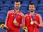 Mate Pavic and Nikola Mektic of Croatia pose with their gold medals. 
