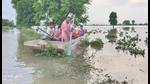 A farmer uses a boat in his submerged fields in Moonak on Friday. (HT Photo) A farmer uses a boat in his submerged fields in Moonak on Friday. (HT Photo)