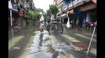 A handpulled rickshaw puller waits for commuters on a waterlogged street in Kolkata on Friday. (Samir Jana/HT Photo) A handpulled rickshaw puller waits for commuters on a waterlogged street in Kolkata on Friday. (Samir Jana/HT Photo)