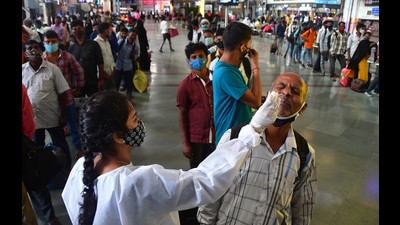 A BMC health worker collects swab samples for Covid-19 test of passengers arriving from outstation trains at CSMT station, in Mumbai on July 14, 2021. (HT PHOTO)