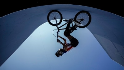 Chelsea Wolfe of the United States, an openly transgender athelete, rides horizontally on the side wall, seen from below, during a BMX Freestyle training session at the 2020 Summer Olympics, on July 28 in Tokyo. (Ben Curtis / AP) Chelsea Wolfe of the United States, an openly transgender athelete, rides horizontally on the side wall, seen from below, during a BMX Freestyle training session at the 2020 Summer Olympics, on July 28 in Tokyo. (Ben Curtis / AP)