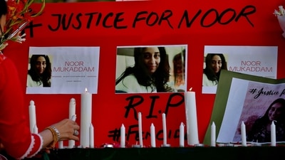 A women's rights activist places a candle beside a poster with the pictures of Noor Mukadam, who was recently beheaded, in Islamabad, Pakistan. (AP) A women's rights activist places a candle beside a poster with the pictures of Noor Mukadam, who was recently beheaded, in Islamabad, Pakistan. (AP)