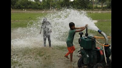 Children play in water from a groundwater pump on a hot summer day in a field on the outskirts of Lucknow (AP Photo)