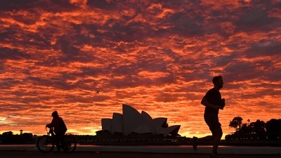 A jogger runs past the Sydney Opera House at dawn in Sydney, Wednesday, July 28, 2021. Australia’s largest city Sydney will remain in lockdown for another four weeks due to a growing Covid-19 cluster. (Mick Tsikas/AAP Image via AP) A jogger runs past the Sydney Opera House at dawn in Sydney, Wednesday, July 28, 2021. Australia’s largest city Sydney will remain in lockdown for another four weeks due to a growing Covid-19 cluster. (Mick Tsikas/AAP Image via AP)