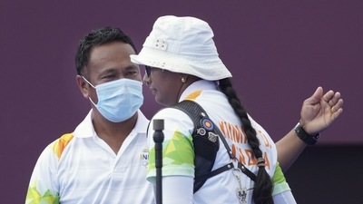 India's Deepika Kumari with coach Dharmendra Tiwary after winning in the women's individual 1/8 eliminations round of the archery event, at the Summer Olympics 2020. (PTI)
