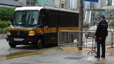 A prison van arrives as a police officer stands guard for Tong Ying-kit's arrival at the Hong Kong High Court in Hong Kong Friday, July 30, 2021. Tong was convicted Tuesday of inciting secession and terrorism for driving his motorcycle into a group of police officers during a July 1, 2020, pro-democracy rally while carrying a flag bearing the banned slogan, "Liberate Hong Kong, revolution of our times." Tong, 24, will be sentenced Friday, the court announced. (AP Photo/Vincent Yu) (AP) A prison van arrives as a police officer stands guard for Tong Ying-kit's arrival at the Hong Kong High Court in Hong Kong Friday, July 30, 2021. Tong was convicted Tuesday of inciting secession and terrorism for driving his motorcycle into a group of police officers during a July 1, 2020, pro-democracy rally while carrying a flag bearing the banned slogan, "Liberate Hong Kong, revolution of our times." Tong, 24, will be sentenced Friday, the court announced. (AP Photo/Vincent Yu) (AP)