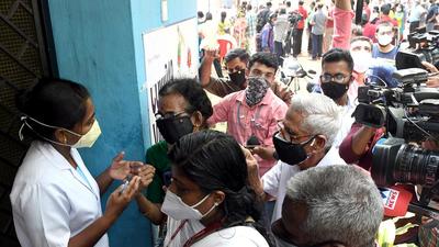 Locals interact with a health worker as they wait for their turn to get vaccinated at the general hospital in Thiruvananthapuram. (ANI) Locals interact with a health worker as they wait for their turn to get vaccinated at the general hospital in Thiruvananthapuram. (ANI)