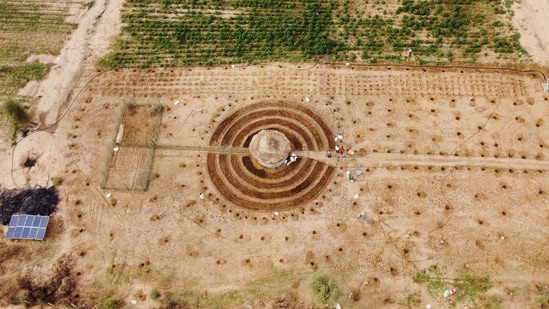 An aerial view of participants of a Tolou Keur programme working on a newly built garden in Boki Diawe, within the Great Green Wall area, in Matam region, Senegal, on July 10, 2021. Gardens known as Tolou Keur hold plants and trees resistant to hot, dry climates, and are planted with circular beds that allow roots to grow inwards, trapping liquids and bacteria and improving water retention and composting.(Zohra Bensemra / REUTERS)