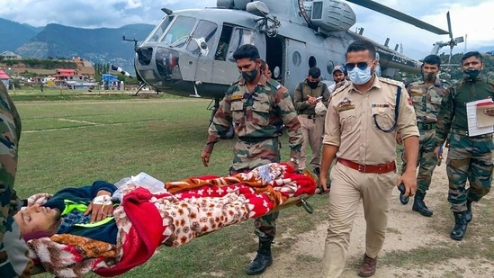Army and police personnel rescuing a civilian in Kishtwar district of J&amp;K. (File Photo / PTI)