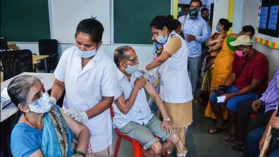 Health workers administer Covid-19 vaccine dose to senior citizens at a school-turned-vaccination centre in Thane on July 7. (PTI)