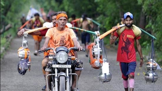 Noida, India - July 28, 2019: Kanwariyas seen on their way to Okhla Bird Sanctuary while coming back from Haridwar carrying water from the Ganga River, in Noida, India, on Sunday, July 28, 2019. (Photo by Sunil Ghosh / Hindustan Times)