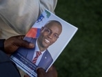 A person holds a photo of late Haitian President Jovenel Moise, who was shot dead earlier this month, during his funeral at his family home in Cap-Haitien, Haiti.(Reuters)