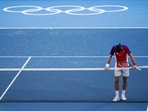 Novak Djokovic, of Serbia, reacts after being defeated by Pablo Carreno Busta, of Spain, in the bronze medal match of the tennis competition at the 2020 Summer Olympics.