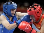 Pooja Rani (red) of India exchanges punches with Qian Li of China. (Getty Images) Pooja Rani (red) of India exchanges punches with Qian Li of China. (Getty Images)