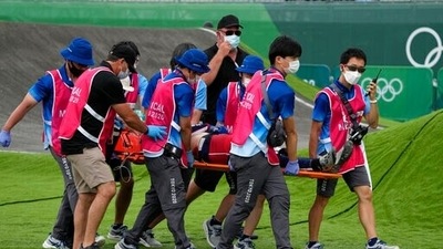 Medics carry away on a stretcher Connor Fields of the United States after he crashed at the first bend in the men's BMX Racing semifinals at the 2020 Summer Olympics. (AP)