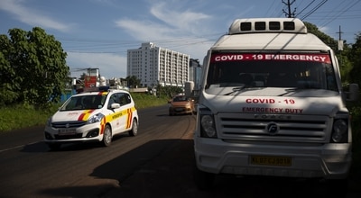 A vehicle used for COVID-19 emergency is parked on a roadside as other vehicles drive past during a weekend lockdown to curb the spread of coronavirus in Kochi, Kerala. (AP Photo) A vehicle used for COVID-19 emergency is parked on a roadside as other vehicles drive past during a weekend lockdown to curb the spread of coronavirus in Kochi, Kerala. (AP Photo)