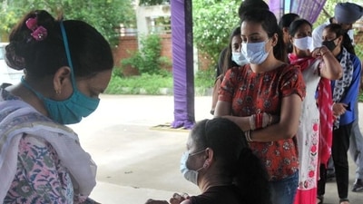 A health worker administering Covid vaccine to a resident at a special vaccination camp at the sports stadium in Mohali’s Sector 78 on Friday. (Ravi Kumar/HT) A health worker administering Covid vaccine to a resident at a special vaccination camp at the sports stadium in Mohali’s Sector 78 on Friday. (Ravi Kumar/HT)