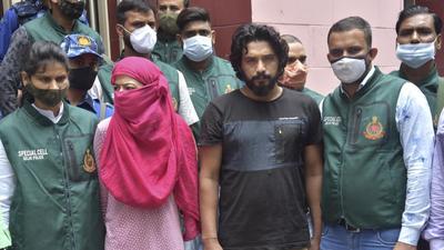 Gangster Kala Jatheri, with his partner, Anuradha Chaudhary, in police custody on Saturday. (PTI Photo) Gangster Kala Jatheri, with his partner, Anuradha Chaudhary, in police custody on Saturday. (PTI Photo)