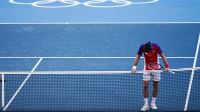 Novak Djokovic, of Serbia, reacts after being defeated by Pablo Carreno Busta, of Spain, in the bronze medal match of the tennis competition at the 2020 Summer Olympics. (AP) Novak Djokovic, of Serbia, reacts after being defeated by Pablo Carreno Busta, of Spain, in the bronze medal match of the tennis competition at the 2020 Summer Olympics. (AP)