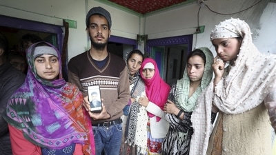 Family members of Gulab Nabi, who died in the flash floods, share a picture of the victim with the media. (PTI) Family members of Gulab Nabi, who died in the flash floods, share a picture of the victim with the media. (PTI)