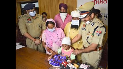 Ludhiana police commissioner Rakesh Agrawal handing over the custody of the rescued child to his family members at the Police Lines on Saturday. (Gurpreet Singh/HT) Ludhiana police commissioner Rakesh Agrawal handing over the custody of the rescued child to his family members at the Police Lines on Saturday. (Gurpreet Singh/HT)