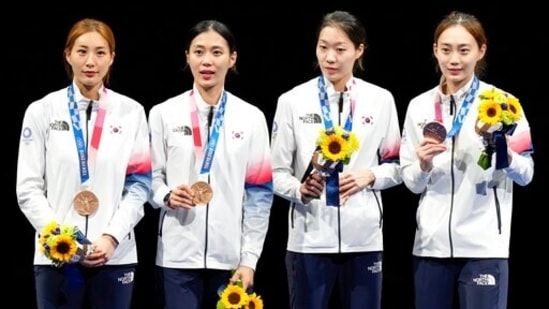 Bronze medalists of South Korea celebrate on the podium of the women's Sabre team at the 2020 Summer Olympics, Saturday, July 31, 2021, in Chiba, Japan. (AP Photo/Andrew Medichini)(AP)