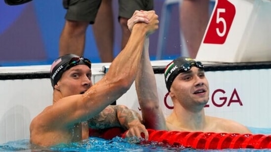 Gold medalist Caeleb Dressel, left, of United States, celebrates with Kristof Milak, of Hungary, after the men's 100-meter butterfly final at the 2020 Summer Olympics, Saturday, July 31, 2021, in Tokyo, Japan. Milak won silver. (AP Photo/Jae C. Hong)(AP)