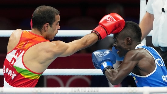 Tokyo: India's Amit Panghal lands a punch on Colombia's Yuberjen Martinez in the Men's Flyweight Round of 16 boxing match, at the Summer Olympics 2020 in Tokyo, Saturday, July 31, 2021. Martinez won 4-1. (PTI Photo/Gurinder Osan)(PTI07_31_2021_000025B)(PTI)