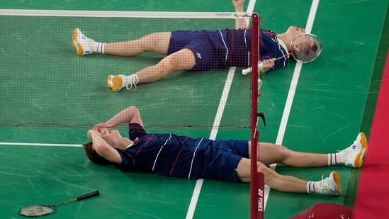Malaysia's Malaysia's Aaron Chia and Soh Wooi Yik celebrate after winning against Indonesia's Mohammad Ahsan and Hendra Setiawan during their badminton men's doubles bronze medal match at the 2020 Summer Olympics, Saturday, July 31, 2021, in Tokyo, Japan. (AP Photo/Markus Schreiber)(AP)