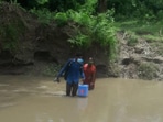 Health workers cross rivulet in Tripura to ensure Covid-19 vaccination to people living in remote villages. Health workers cross rivulet in Tripura to ensure Covid-19 vaccination to people living in remote villages.