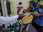 A motorcyclist pays while refueling at a Bharat Petroleum Corp. gas station in Jalgaon, Maharashtra, India, on Monday, July 19, 2021. A motorcyclist pays while refueling at a Bharat Petroleum Corp. gas station in Jalgaon, Maharashtra, India, on Monday, July 19, 2021.