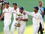 India's Rishabh Pant carries the trophy as he celebrates with his teammates after defeating Australia by three wickets on the final day of the fourth cricket test at the Gabba, Brisbane,(AP) India's Rishabh Pant carries the trophy as he celebrates with his teammates after defeating Australia by three wickets on the final day of the fourth cricket test at the Gabba, Brisbane,(AP)