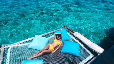Mouni Roy: The Bengali beauty travelled to the island country in September 2020. In this still, Mouni can be seen basking in the sun wearing a bright yellow bikini. (Instagram/@imouniroy)