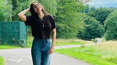 Anushka's short hair was left open, gold hoops in her ears, gold chains around her neck and bracelets to accessorize her look which she completed with white sneakers. (Instagram) Anushka's short hair was left open, gold hoops in her ears, gold chains around her neck and bracelets to accessorize her look which she completed with white sneakers. (Instagram)