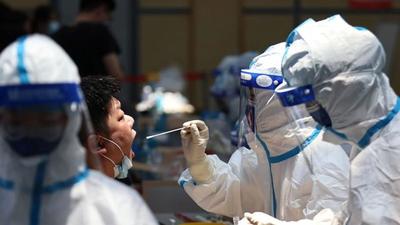 A medical worker in protective suit collects swab from a resident for nucleic acid testing at a sports centre in Jiangning district, following new cases of the coronavirus disease in Nanjing, Jiangsu province, China. (REUTERS) A medical worker in protective suit collects swab from a resident for nucleic acid testing at a sports centre in Jiangning district, following new cases of the coronavirus disease in Nanjing, Jiangsu province, China. (REUTERS)