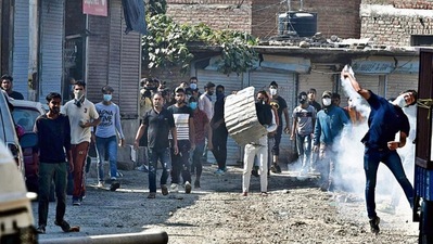 Protesters throw stones at security forces at the Batamaloo area of Srinagar on September 17. ANI Protesters throw stones at security forces at the Batamaloo area of Srinagar on September 17. ANI