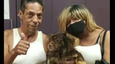 The image shows Payday with his humans. (Wisconsin Humane Society)