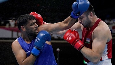 Bakhodir Jalolov (red) of Team Uzbekistan exchanges punches with Satish Kumar of India (Getty Images) Bakhodir Jalolov (red) of Team Uzbekistan exchanges punches with Satish Kumar of India (Getty Images)