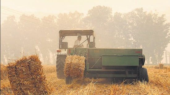 A baler making stubble bales in a Punjab village. (HT File)