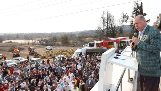 Turkish President Recep Tayyip Erdogan addresses locals as he visits the wildfire disaster zones Manavgat and Marmaris, near Manavgat, Turkey on July 31.(REUTERS)