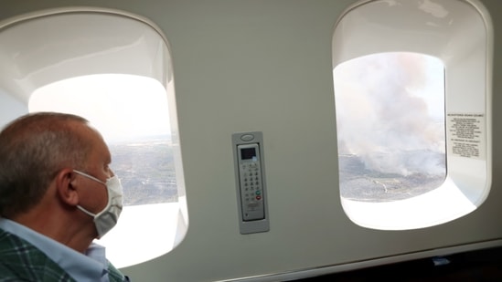 Turkish President Recep Tayyip Erdogan looks at wildfire from the window of his helicopter in Marmaris, Turkey.(REUTERS)